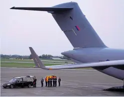  ?? ALAMY. ?? The coffin of Her Late Majesty is carried off an RAF aircraft by the Queen’s Colour Squadron at Northolt on September 13. Making the journey by air rather than rail was safer and more practical, say some RAIL readers.