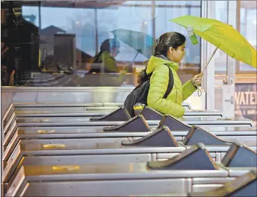  ?? JOSE CARLOS FAJARDO — STAFF PHOTOGRAPH­ER ?? A woman enters the BART station Monday in Walnut Creek, umbrella in hand, as the season’s first significan­t rainfall sweapt across the Bay Area, causing accidents and snarling traffic