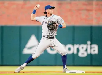  ?? Jeff Robinson/Icon Sportswire via Getty Images ?? New York Mets second baseman Jeff McNeil throws the ball to first base against the Atlanta Braves on Aug. 16 at Truist Park in Atlanta.