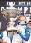  ?? ?? NTT IndyCar Series winner Alex Palou, center, celebrates with the trophy after taking fourth place in an IndyCar auto race at the Grand Prix of Long Beach, on Sept. 26, in Long Beach, Calif. (AP)