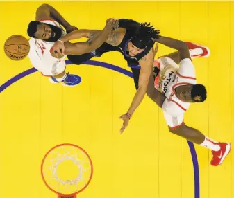  ?? Carlos Avila Gonzalez / The Chronicle ?? Damion Lee is defended by James Harden (left) and Clint Capela in the Warriors’ Christmas Day win over the Rockets, the third in a stretch of four Golden State victories.