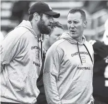  ?? STAFF FILE PHOTO BY ROBIN RUDD ?? From left, assistant coaches Nick Hennessey and Greg Harbaugh Jr. talk during warmups before the VMI contest this year. Mocs coach Tom Arth fired the two assistants after a 6-5 season.