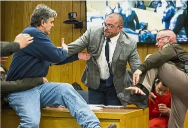  ?? — AP ?? Dramatic take-down: Margraves (left) lunging at Nassar (bottom right) in the courtroom just before he is tackled and restrained by Eaton County Sheriff’s deputies (pictures below).
