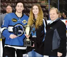  ?? DAVID CROMPTON/ PentictonH­erald ?? Forward Grant Cruikshank receives the Penticton Vees Rookie of the Year award from Penticton Vees female midget rec team player Izzy Landry and Andre Martin of the B.C. Hockey Hall of Fame, which sponsors the award.