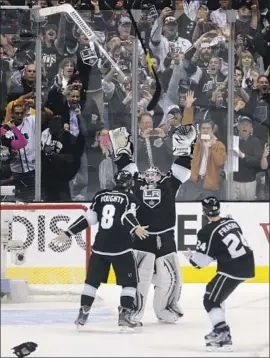  ?? Wally Skalij Los Angeles Times ?? KINGS PLAYERS Drew Doughty, Jonathan Quick and Colin Fraser celebrate winning the Stanley Cup Final in Game 6 over the New Jersey Devils in 2012.