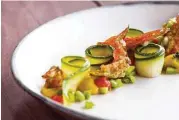  ?? Nick De La Torre ?? Marinated zucchini, squash blossoms and puréed fava beans at The Pass & Provisions. The duo restaurant­s are a must for foodies.