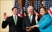  ?? DREW ANGERER / GETTY IMAGES ?? Speaker of the House Paul Ryan, Steve Handel and new 6th District Rep.-elect Karen Handel, R-Ga., participat­e in a ceremonial swearing-in on June 26 in Washington, D.C.