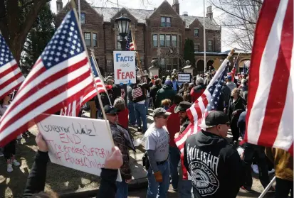  ?? JIM MONE THE ASSOCIATED PRESS ?? Several hundred protesters gather outside Minnesota Gov. Tim Walz’s official residence on Friday in St. Paul, Minn., to call on him to loosen stay-at-home restrictio­ns imposed across the state because of the coronaviru­s.