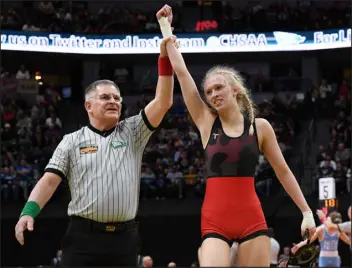  ?? KATHRYN SCOTT — DENVER POST FILE ?? Loveland High School senior Morgan Johnson, right, won state titles in CHSAA’S first two officially sanctioned girls wrestling tournament­s, in addition to a title won as a freshman when the associatio­n ran a pilot tournament in Thornton.