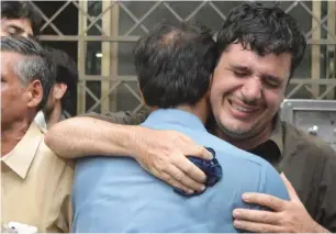  ?? AP ?? Relative mourn the death of their family member at a hospital in Peshawar after the blast. —