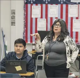  ?? Allen J. Schaben Los Angeles Times ?? TEACHER Lorraine Escalante helps Dylan Camacho at Griffith STEAM Magnet Middle School. The teachers union called the tentative pact “groundbrea­king.”