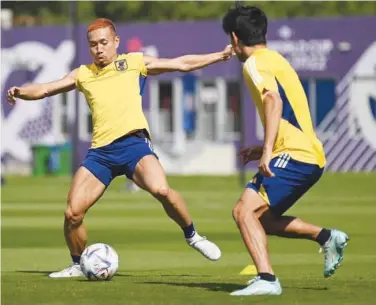  ?? A g ence France-presse ?? Japan’s Yuto Nagatomo (left) and Takefusa Kubo take part in a training session at Al Sadd stadium in Doha.