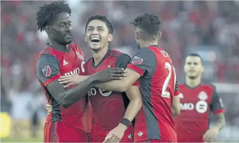  ?? CHRIS YOUNG/THE CANADIAN PRESS ?? Toronto FC’s Marco Delgado (centre) celebrates with Tosaint Ricketts (left) and Jonathan Osorio after scoring his team’s fourth goal against the Portland Timbers during the second half of their game on Aug. 12.