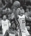  ?? ANDY CLAYTON-KING/AP ?? The Grizzlies’ Desmond Bane, front, shoots as the Timberwolv­es’ Anthony Edward trails on Thursday in Minneapoli­s.