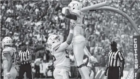  ?? AP PHOTO/ROGER STEINMAN ?? Texas center Zach Shackelfor­d, left, and wide receiver Collin Johnson celebrate a touchdown against Oklahoma on Saturday in Dallas. The No. 19 Longhorns beat the No. 7 Sooners 48-45.