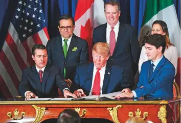  ?? AFP ?? From left: Mexican President Enrique Pena Nieto, US President Donald Trump and Canadian Prime ■ Minister Justin Trudeau sign a new free trade agreement in Buenos Aires yesterday.