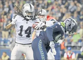  ?? PHOTOS BY ELAINE THOMPSON – THE ASSOCIATED PRESS ?? Raiders wide receiver Keon Hatcher, left spins past Seattle Seahawks defensive back Delano Hill to score a touchdown during the first half of Thursday’s preseason game.,