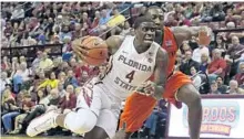  ?? STEVEN CANNON/AP ?? Florida State’s Dwayne Bacon drives to the basket as Miami’s Davon Reed defends in Saturday’s game in Tallahasse­e.