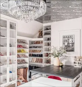  ?? ?? The chandelier in this walk-in closet lends a bit of glam to the space.