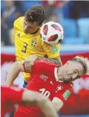  ?? AP PHOTO ?? RISING TO CHALLENGE: Victor Lindelof jumps above Switzerlan­d’s Granit Xhaka for a header during Sweden’s 1-0 victory.