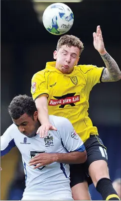  ??  ?? TUSSLE: Bury’s Tom Soares and Burton’s Callum McFadzean in action