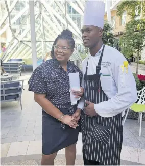  ?? ?? Executive sous chef for Royal Caribbean’s Wonder of the Seas,
Consie “Omar” Cover shares a moment with Julian Haynes, health informatio­n officer at the St Ann’s Bay Hospital, one of 40 health care workers who were feted aboard the Wonder of the Seas.