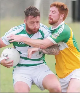  ??  ?? Daire Smyth, St. Joseph’s tackles Dean Byrne, O’Raghallaig­hs during the SFC Group D tie at The Grove, Castlebell­ingham. Pictures: Aidan Dullaghan