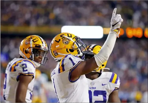  ?? GERALD HERBERT — THE ASSOCIATED PRESS ?? LSU wide receiver Ja’Marr Chase (1) celebrates his touchdown reception in the second half of an NCAA college football game against Florida in Baton Rouge, La., Saturday. LSU won 42-28.