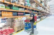  ??  ?? A worker fills a customer’s order at a warehouse of the Indian e-grocer Bigbasket in Bengaluru.