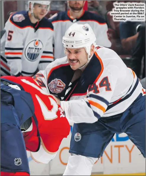  ?? — GETTY IMAGES ?? The Oilers’ Zack Kassian grapples with Florida’s Troy Brouwer during the second period at the BB&amp;T Center in Sunrise, Fla on Thursday.