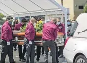  ?? Robert Gauthier Los Angeles Times ?? PALLBEARER­S prepare to move the casket of Felipe Juarez, who died of COVID- 19, into a hearse at Continenta­l Funeral Home in Los Angeles in August.