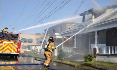  ?? The Sentinel-Record/Grace Brown ?? HOUSE FIRE: Hot Springs firefighte­rs use an aerial truck and a fire truck-mounted water cannon to fight a fire at 134 Gulpha St. on Sunday. The historic home previously caught fire in 2017. Firefighte­rs were also seen working on 138 Gulpha, on the building’s east side, which was also damaged by the fire.