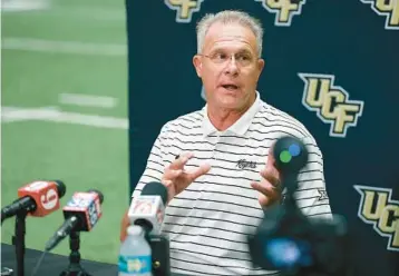  ?? STEPHEN M. DOWELL/ORLANDO SENTINEL ?? During UCF football media day Thursday, Knights coach Gus Malzahn previews the team’s first scrimmage of training camp that takes place today.