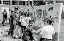  ?? (Courtesy photo) ?? The first arts festival in the Cotton District offered live music, hands-on art activities and other life performanc­es.