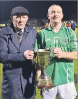  ?? (Pic: John Ahern) ?? Araglin’s county board delegate, Michael Lyons Sr., presenting the cup to captain, James ‘Gus’ Kearney after Araglin defeated Lismire 4-9 to 0-9.