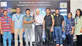  ??  ?? Co-sponsor and guest of honour Transnatio­n Group Chairman Upali De Silva presents People’s Bank ‘D’ team with runner-up trophy in the presence of CAB President M. Razak Deen and Treasurer Asanka Theador