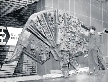  ??  ?? > One of the bulls by Trewin Coppleston­e made for the Bull Ring centre, pictured on October 31, 1963