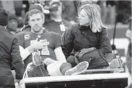  ?? JOHN MCDONNELL/THE WASHINGTON POST ?? Redskins quarterbac­k Alex Smith is carted off the field after breaking his right leg on Nov. 18 against the Texans. His return to football is promising but still uncertain.