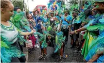  ??  ?? Performers take part in the Notting Hill Carnival.