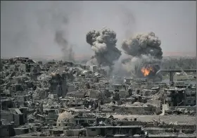  ?? AP/FELIPE DANA ?? Smoke from an airstrike on Islamic State positions rises Tuesday over the Old City area of Mosul in northern Iraq.