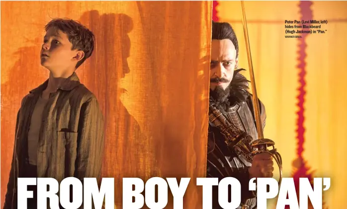  ?? WARNER BROS. ?? Peter Pan (Levi Miller, left) hides from Blackbeard (Hugh Jackman) in “Pan.”