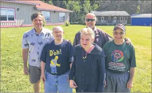  ?? 46#.*55&% 1)050 ?? Dr. Chris Gencheff, second right, returns to the camp that took its name from his late father. From left are Nelson Gencheff and campers Victor, Debbie and John.