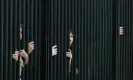  ?? Photograph: Kevin Dietsch/Getty Images ?? Members of the public peer through the White House fence as they wait for BTS to arrive.