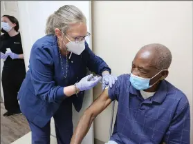  ?? (Arkansas Democrat-Gazette/Thomas Metthe) ?? Nurse Lynn Carter gives Willie Hance a covid-19 vaccine shot Thursday at Doctor’s Orders Pharmacy in Pine Bluff.