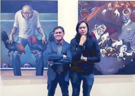  ??  ?? Photograph­ed against their respective works are artists Elmer Borlongan and Igan D’Bayan during the opening of the exhibit.
