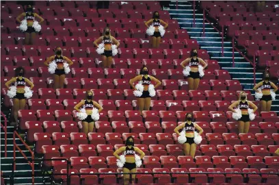  ?? JOHN LOCHER — THE ASSOCIATED PRESS ?? UNLV cheerleade­rs in the stands against Fresno State during the second half of a college basketball game on Feb. 24 in Las Vegas.