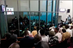  ??  ?? VERDICT: People watch a live broadcast of the verdict in the Netherland­s- based trial of former Liberian president Charles Taylor, at the Special Court for Sierra Leone, in Freetown, Sierra Leone on Thursday. Thousands of people who survived Sierra...