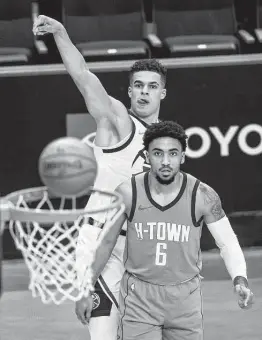  ?? Mark Mulligan / Staff photograph­er ?? Nuggets forward Michael Porter Jr., back, hits a 3-pointer as KJ Martin watches. Porter finished with 21 points, while Martin piled up rebounds late.