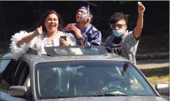  ?? Christian Abraham / Hearst Connecticu­t Media file photo ?? Graduates Miliana Herrera, left, and Ricardo Perez Santana sing as they arrive to get their diplomas during the Ansonia High School graduation in Fairfield on June 20. At right is Ricardo's brother Leonardo Perez Santana.