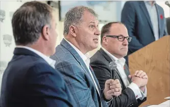  ?? DARREN CALABRESE
THE CANADIAN PRESS ?? CFL commission­er Randy Ambrosie, centre, flanked by Maritime Football partners Bruce Bowser, left, and Anthony LeBlanc, says the group doesn’t have to meet an “artificial threshold” for season-ticket deposits.